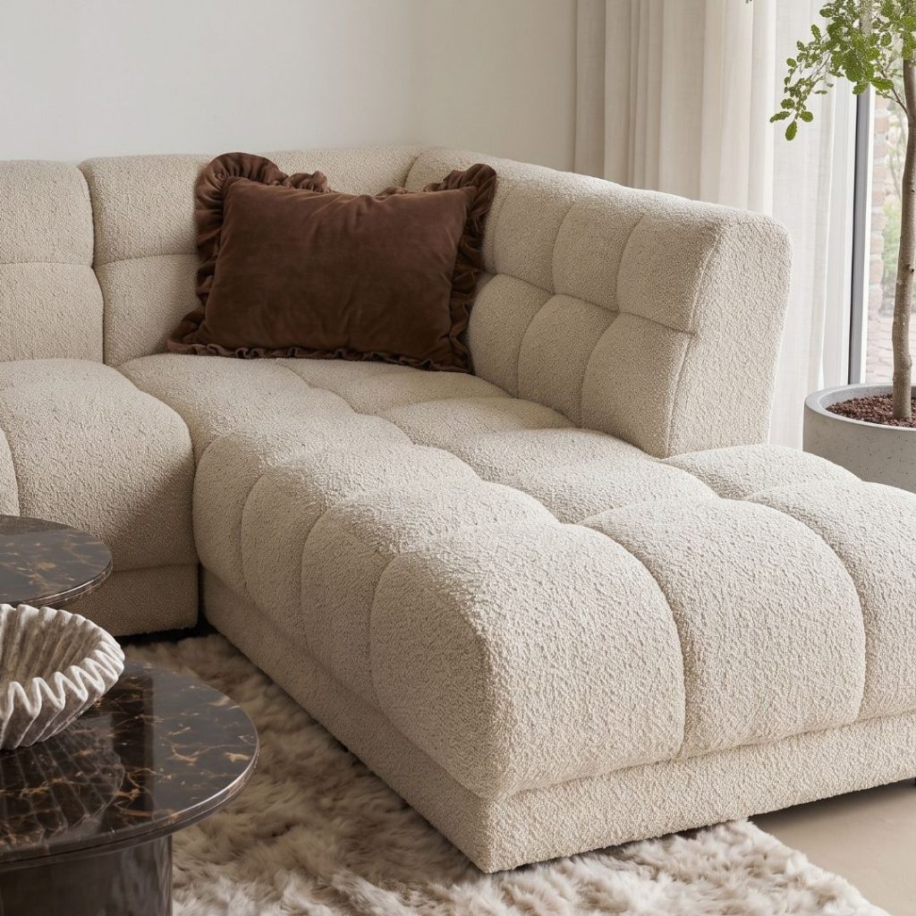Beige bouclé stof van hoekbank Wave met zachte structuur en luxe uitstraling.
